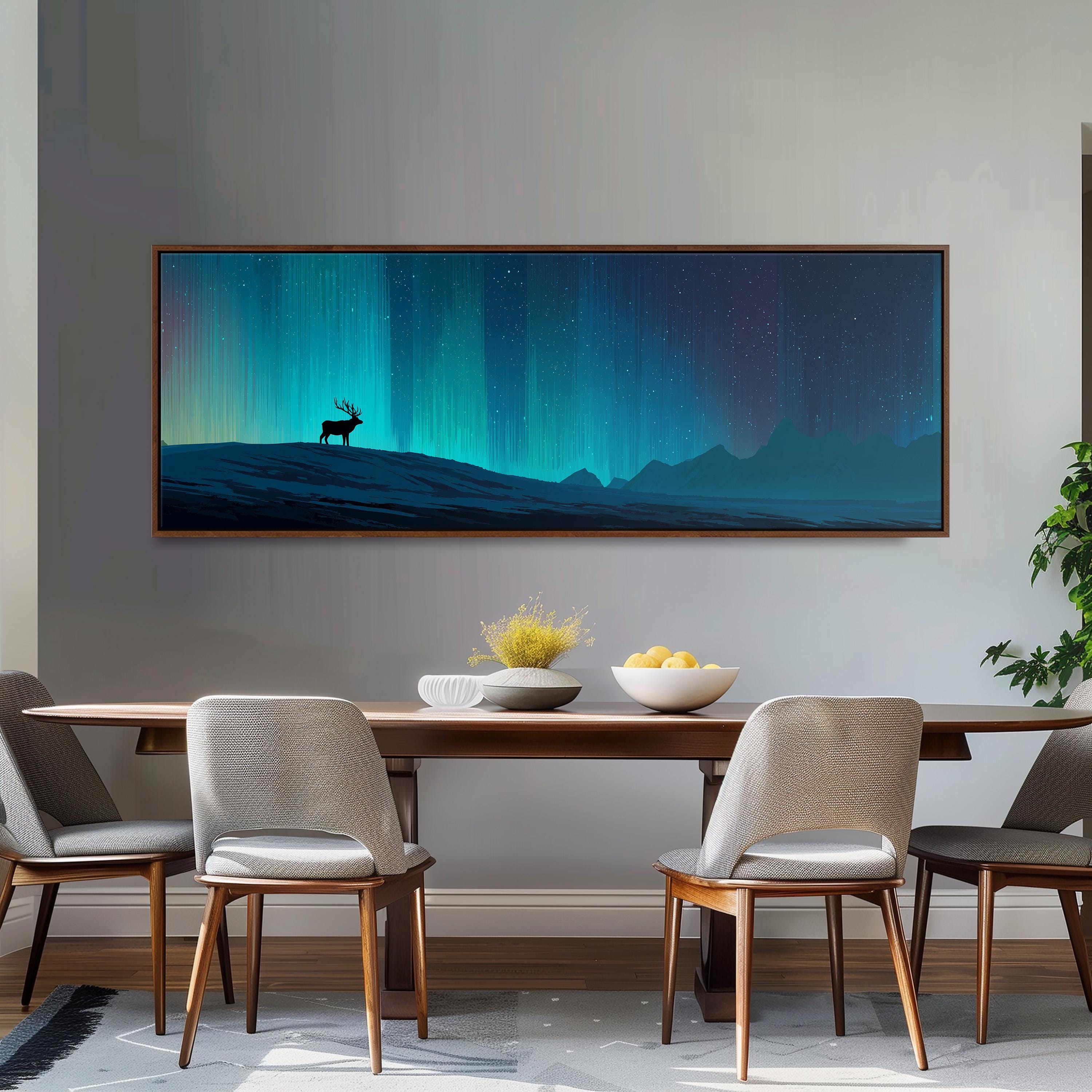 a dining room with a large, framed painting of a deer on a mountain in the background, a wooden dining table with four chairs, and a bowl of fruit on the table.
