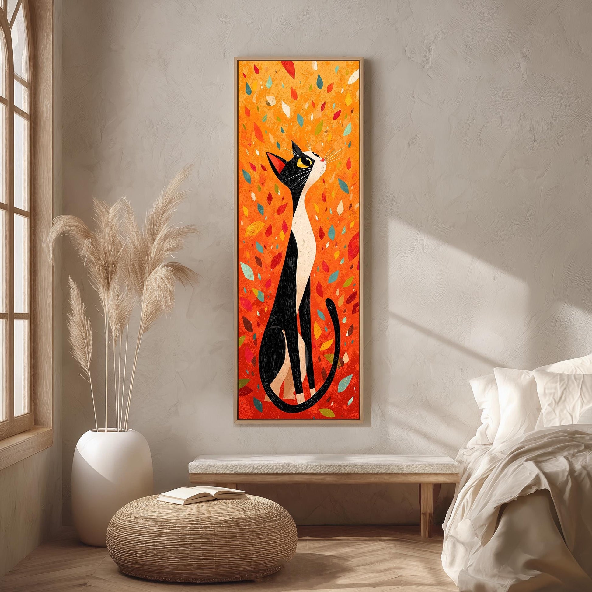 a large, colorful painting of a cat sitting on a bench, with a vibrant background of orange and yellow leaves. The painting is hung on a wall in a room with a bed, a potted plant, and a woven ottoman.