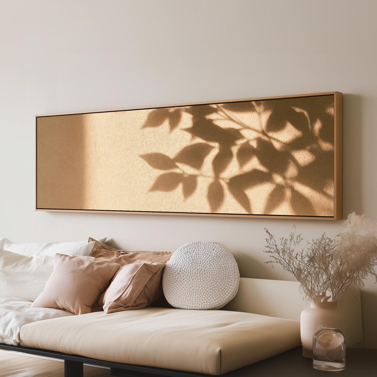 Leaf shadows on a golden plaster wall long horizontal canvas print above a sofa in a living room