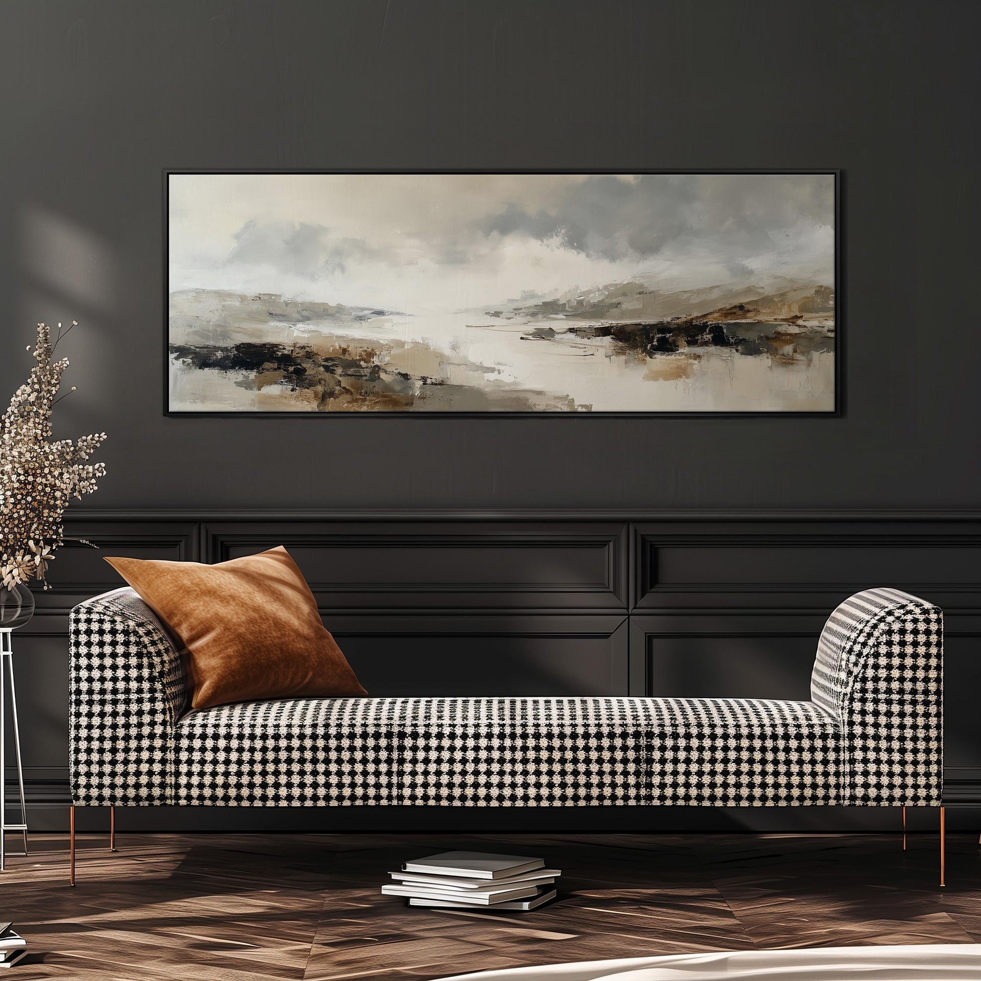 a modern living room with a black and white checkered sofa, a large abstract painting on the wall, and a stack of books on the floor.