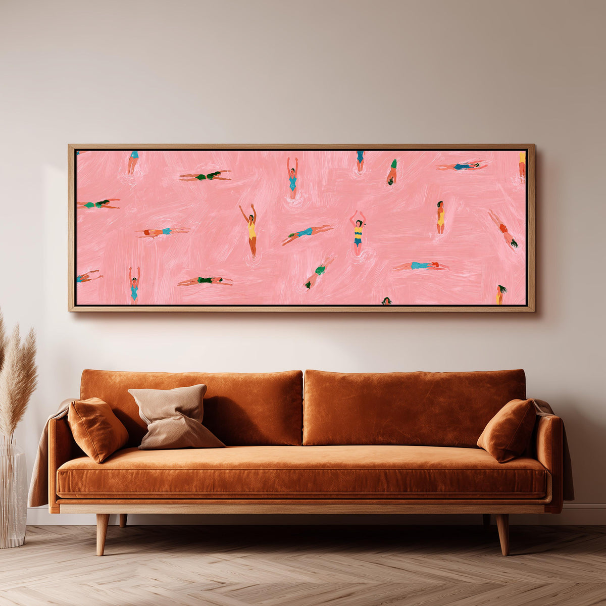 Tiny swimmers in a pink pool from above long horizontal canvas print above a sofa in a living room