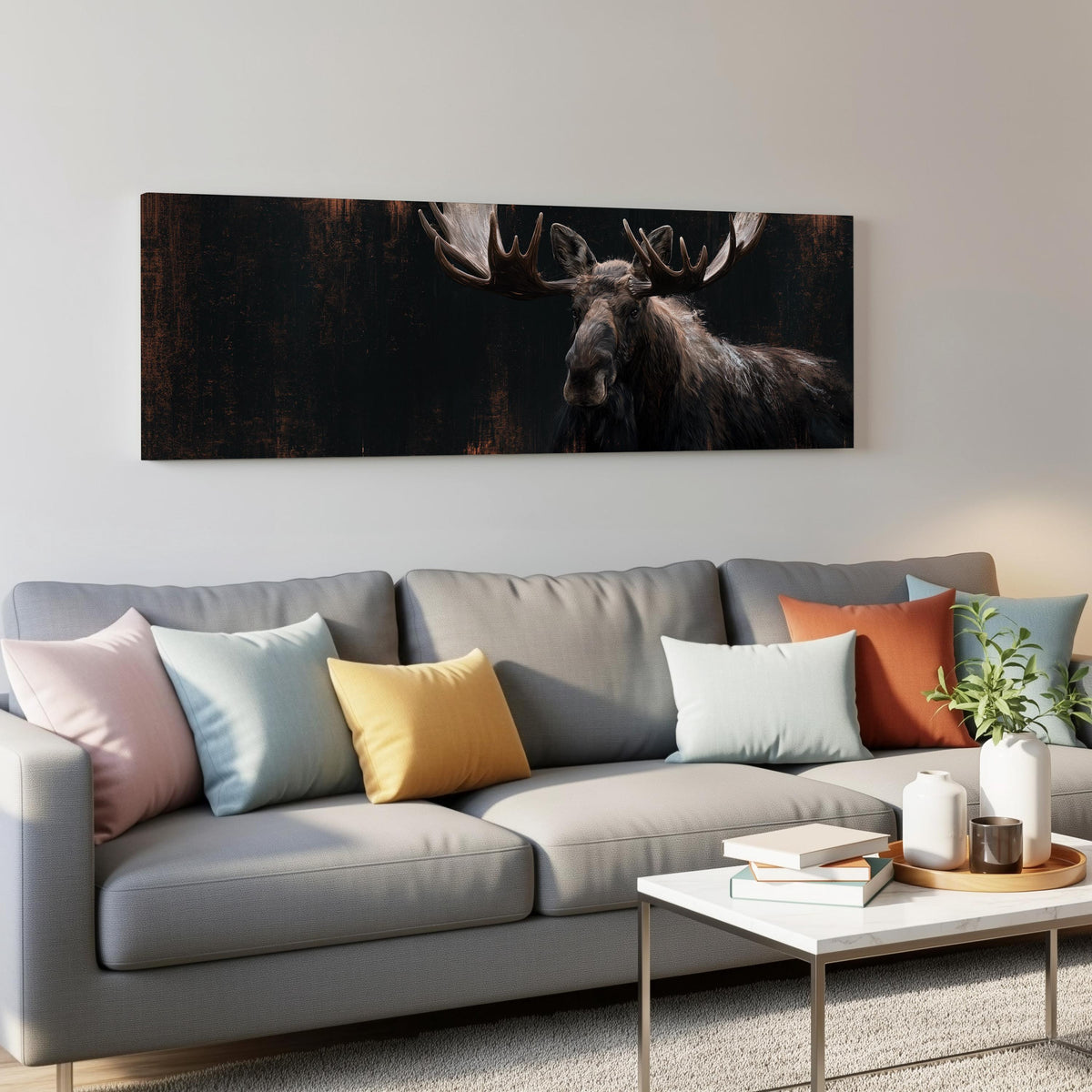 Dark moose portrait panoramic canvas print above a grey sofa in a living room