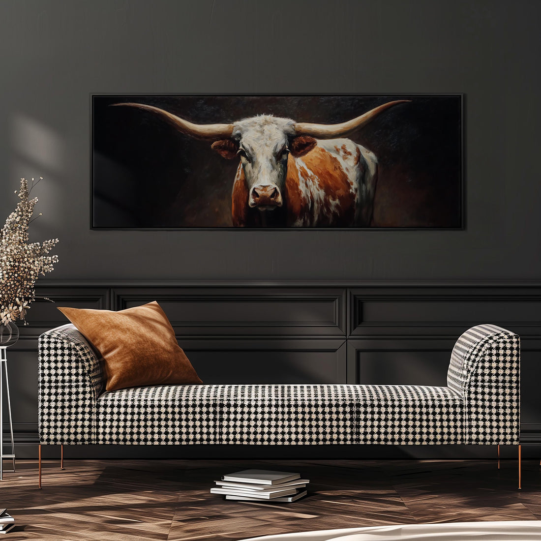 a large painting of a bull with long horns hanging on a wall above a brown sofa.