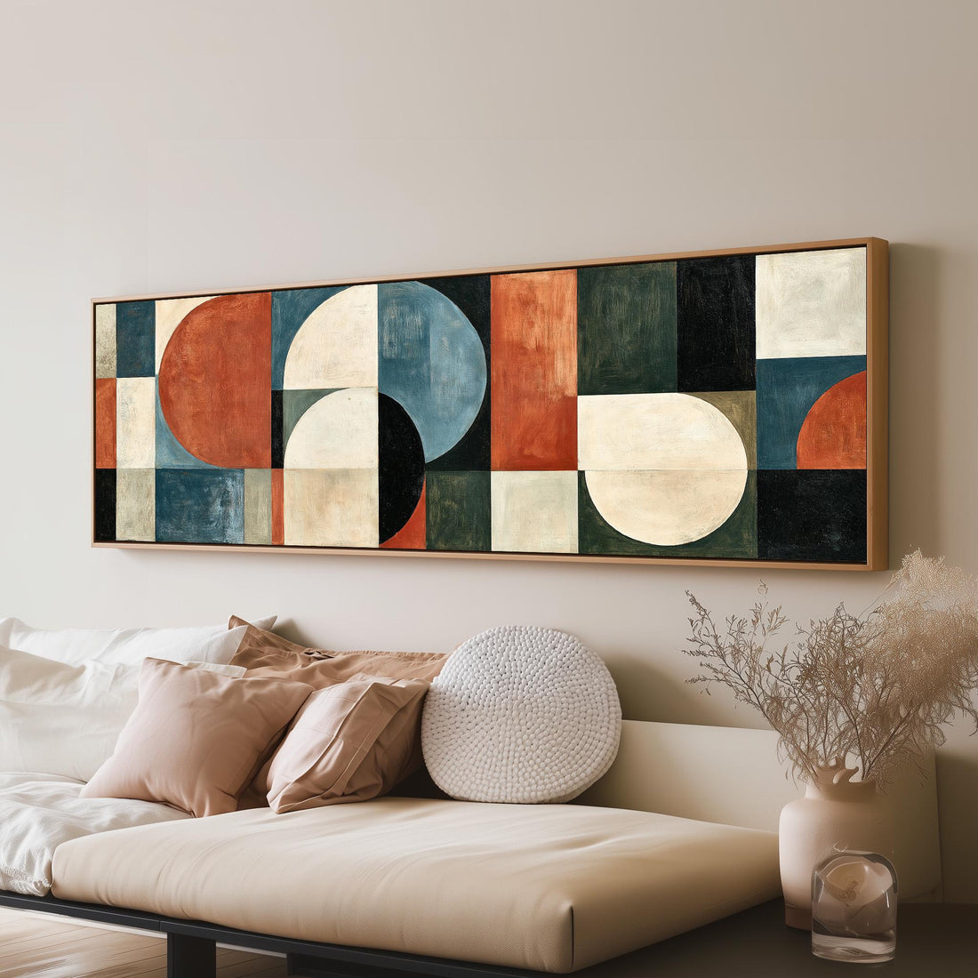 Rust and blue geometric arches and circles long horizontal canvas print above a sofa in a living room