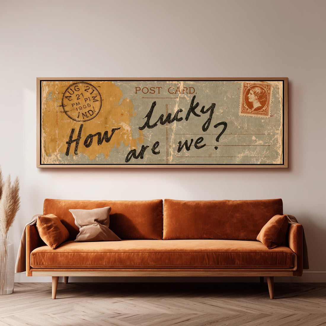 Vintage postcard saying how lucky are we long horizontal canvas print above a sofa in a living room