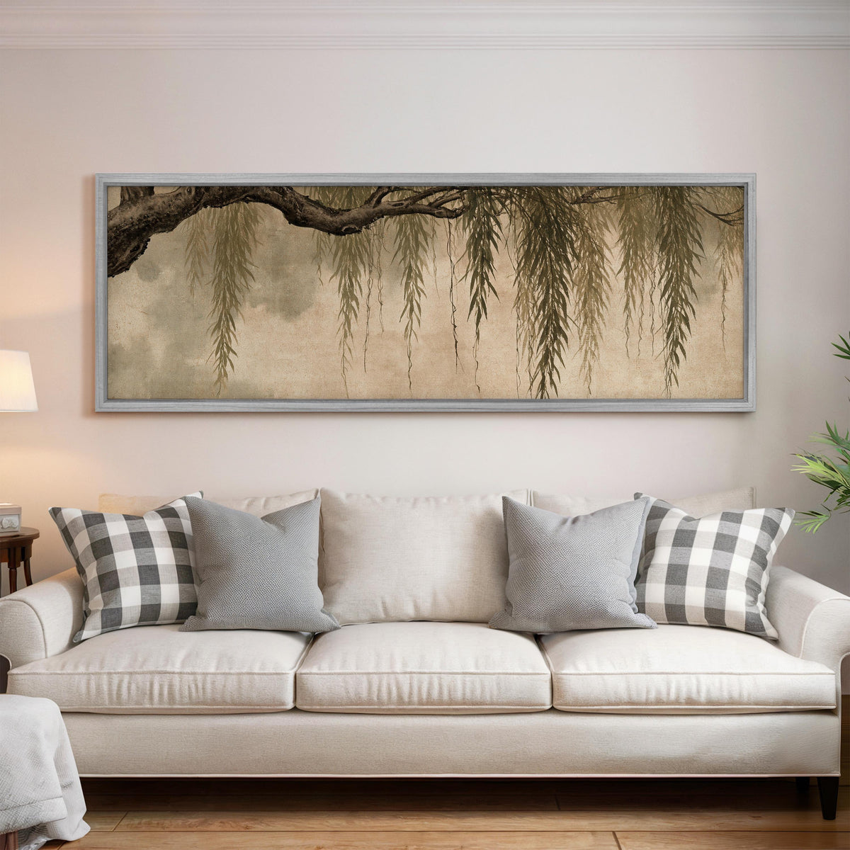 Hanging willow branches panoramic canvas print above a white sofa in a bright living room