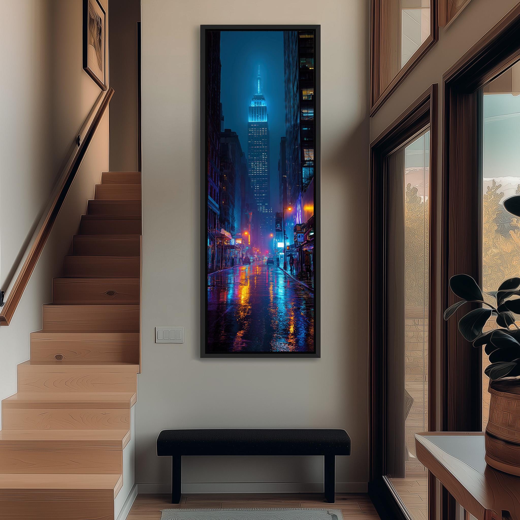 a modern interior with a large framed artwork of a city street at night, featuring the illuminated Empire State Building.