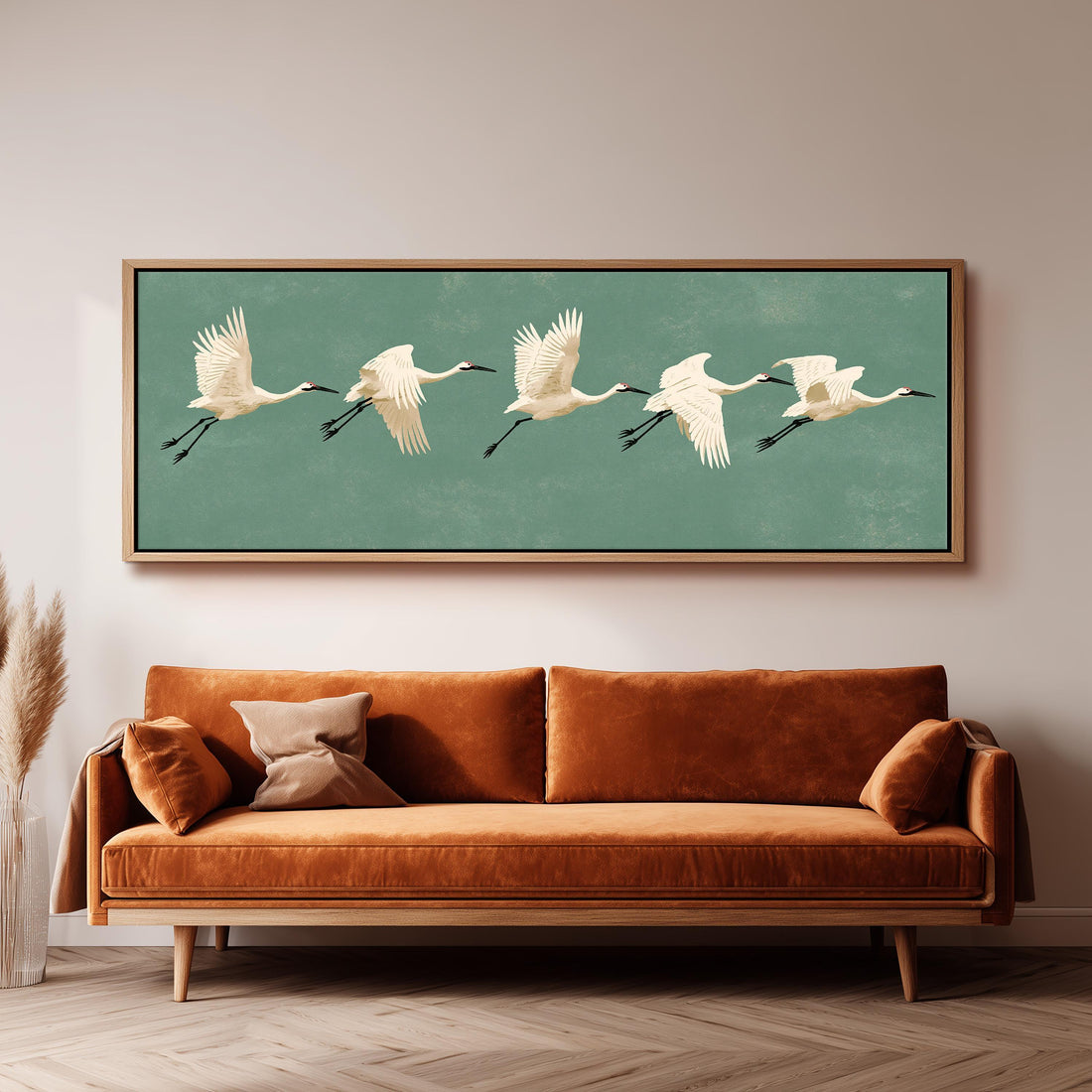 White cranes taking flight long horizontal canvas print above a sofa in a living room