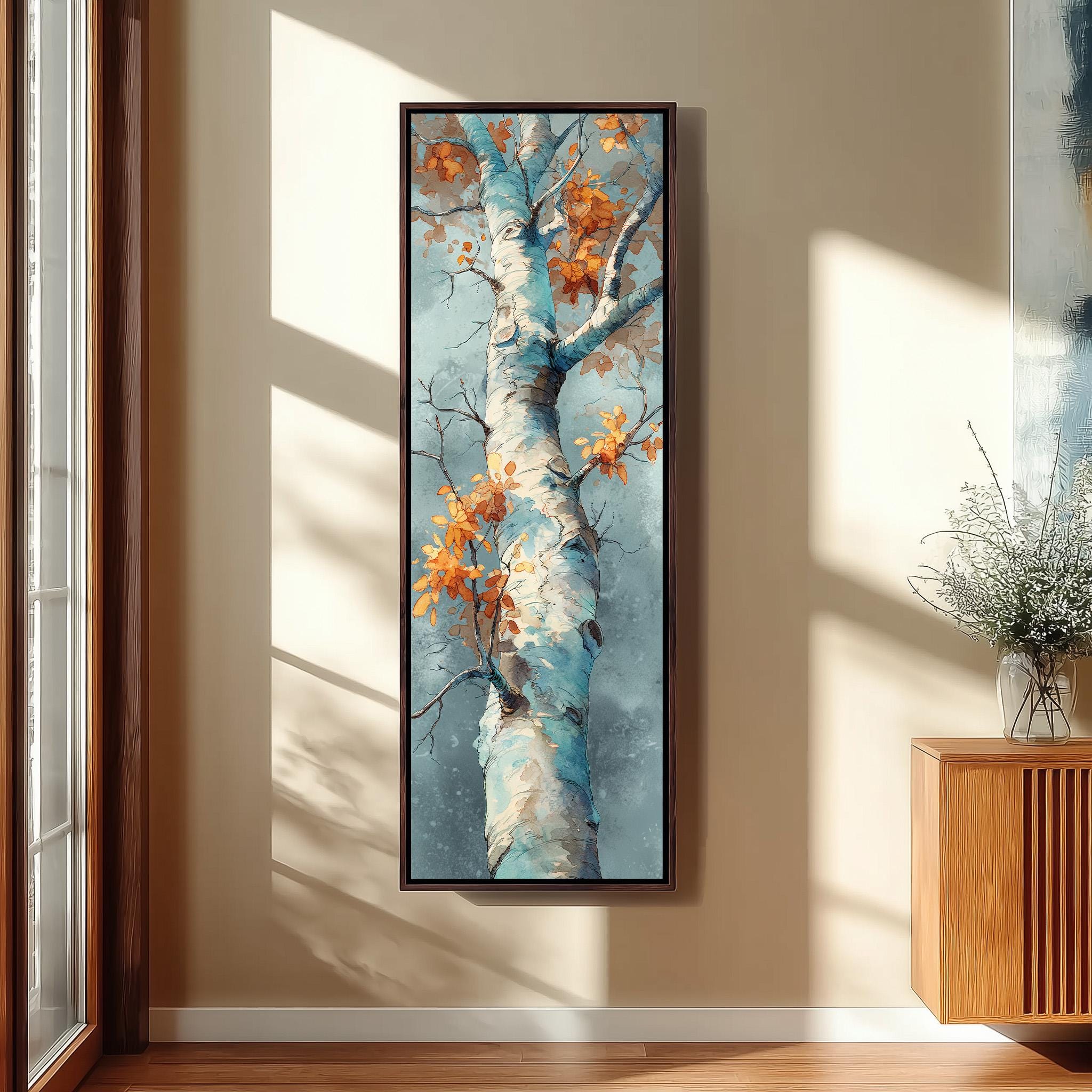 a large, framed painting of a tree with a blue trunk and orange leaves hanging on a wall.