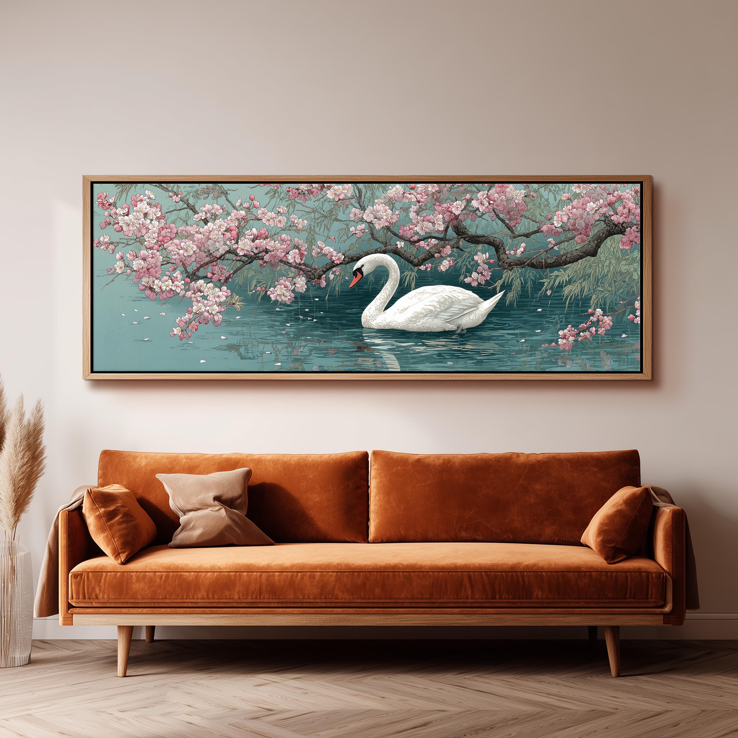 A large painting of a swan floating on a pond, surrounded by blooming pink flowers, hangs on a wall above a brown sofa.