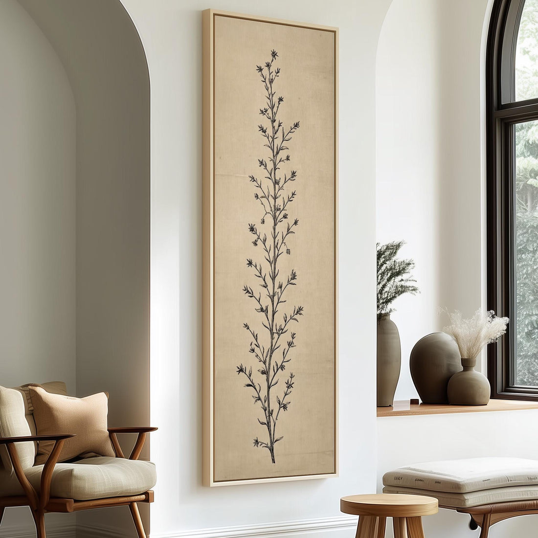 a minimalist living room with a large framed artwork of a tree on the wall, a wooden chair, a small table, and a window with a plant on the sill.