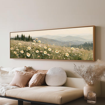 Daisy hillside below blue mountains long horizontal canvas print above a sofa in a living room