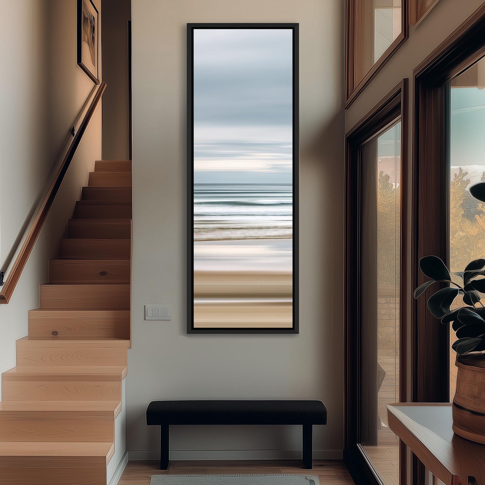 a hallway with a large window that provides a view of the ocean. The window is framed with a black border and has a painting of the ocean hanging on the wall above it. The hallway has a wooden staircase leading up to the second floor, and there is a bench in the foreground.