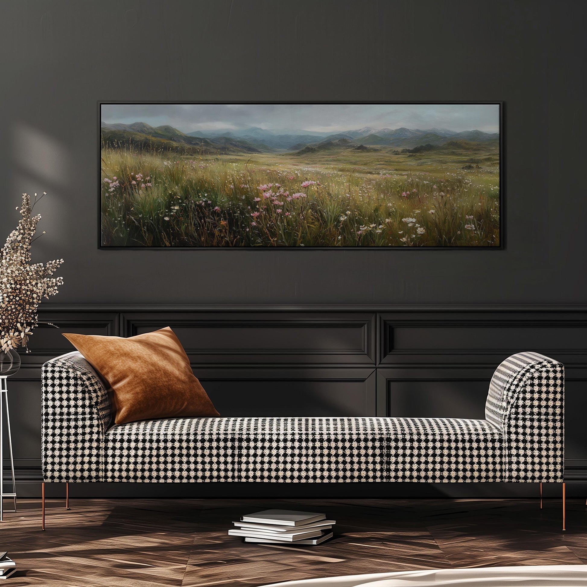 a checkered sofa with a brown throw pillow, set against a dark wall with a large landscape painting hanging above it.