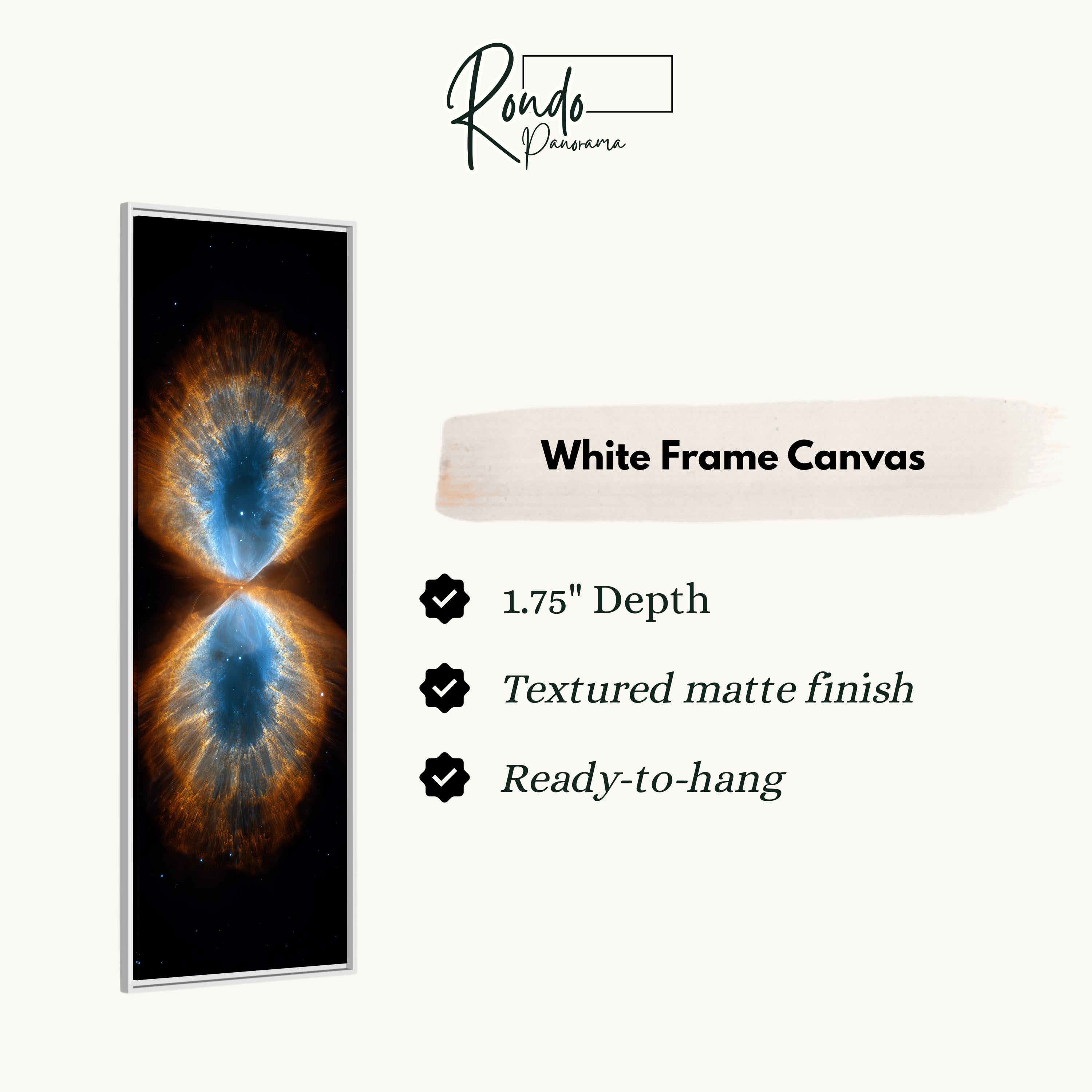 The image is a white frame canvas featuring a captivating image of a nebula, which is a vast cloud of gas and dust in space. The nebula displays a striking contrast of blue and orange hues, creating a visually stunning and eye-catching piece of art. The canvas is described as having a 1.75" depth, a textured matte finish, and is ready to hang.