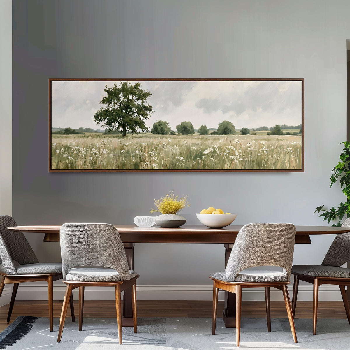 Lone oak tree in a daisy meadow long horizontal canvas print above a dining table
