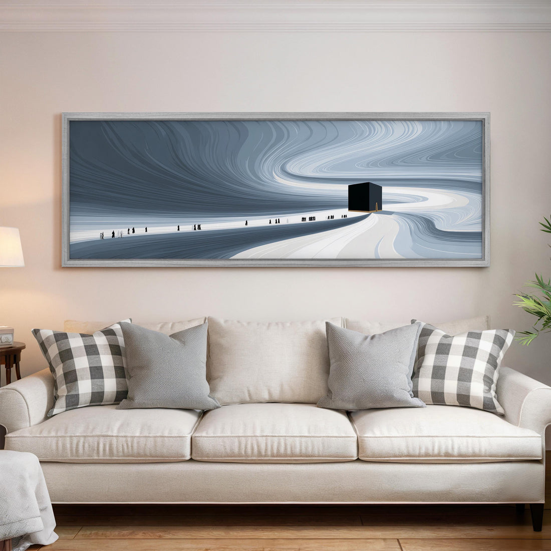 a large, white couch with gray and white patterned throw pillows, and a framed artwork depicting a snowy landscape with a small building in the distance.
