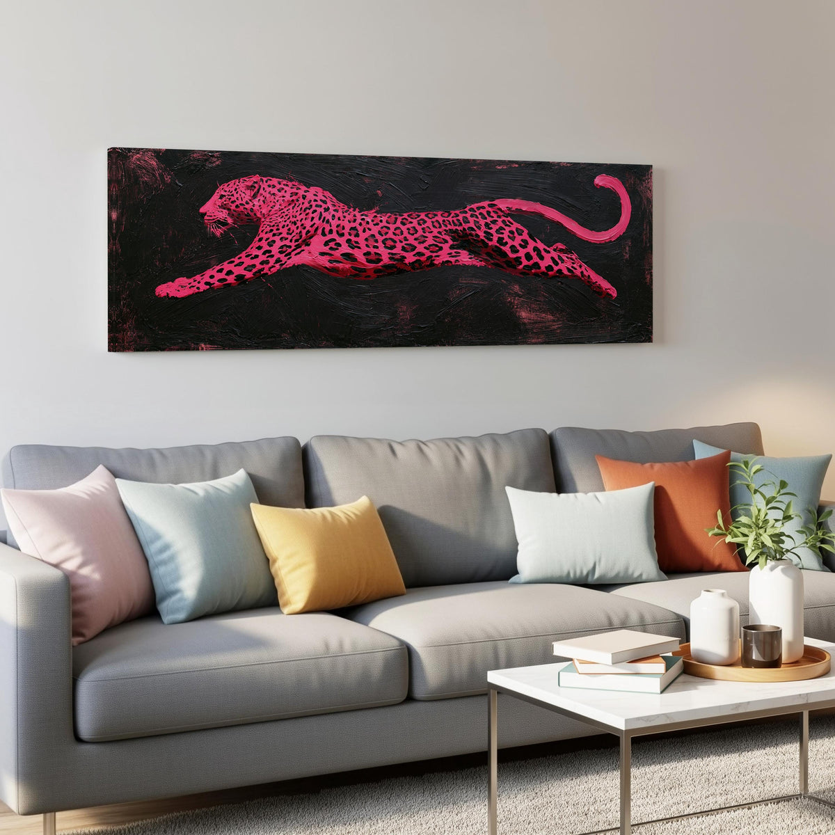 Pink leaping leopard panoramic canvas print above a grey sofa in a living room
