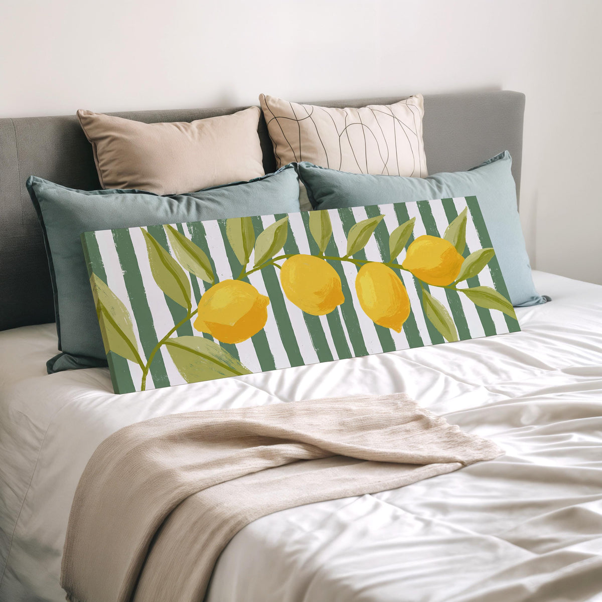 Lemon branch on green stripes wide panoramic canvas print laid on a bed to show its size