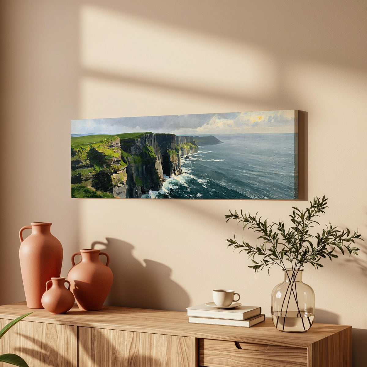 Emerald sea cliffs long horizontal canvas print above a wooden sideboard