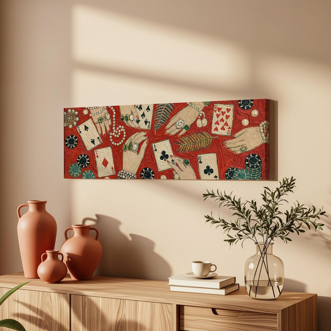 Playing cards, chips and jeweled hands long horizontal canvas print above a sofa in a living room