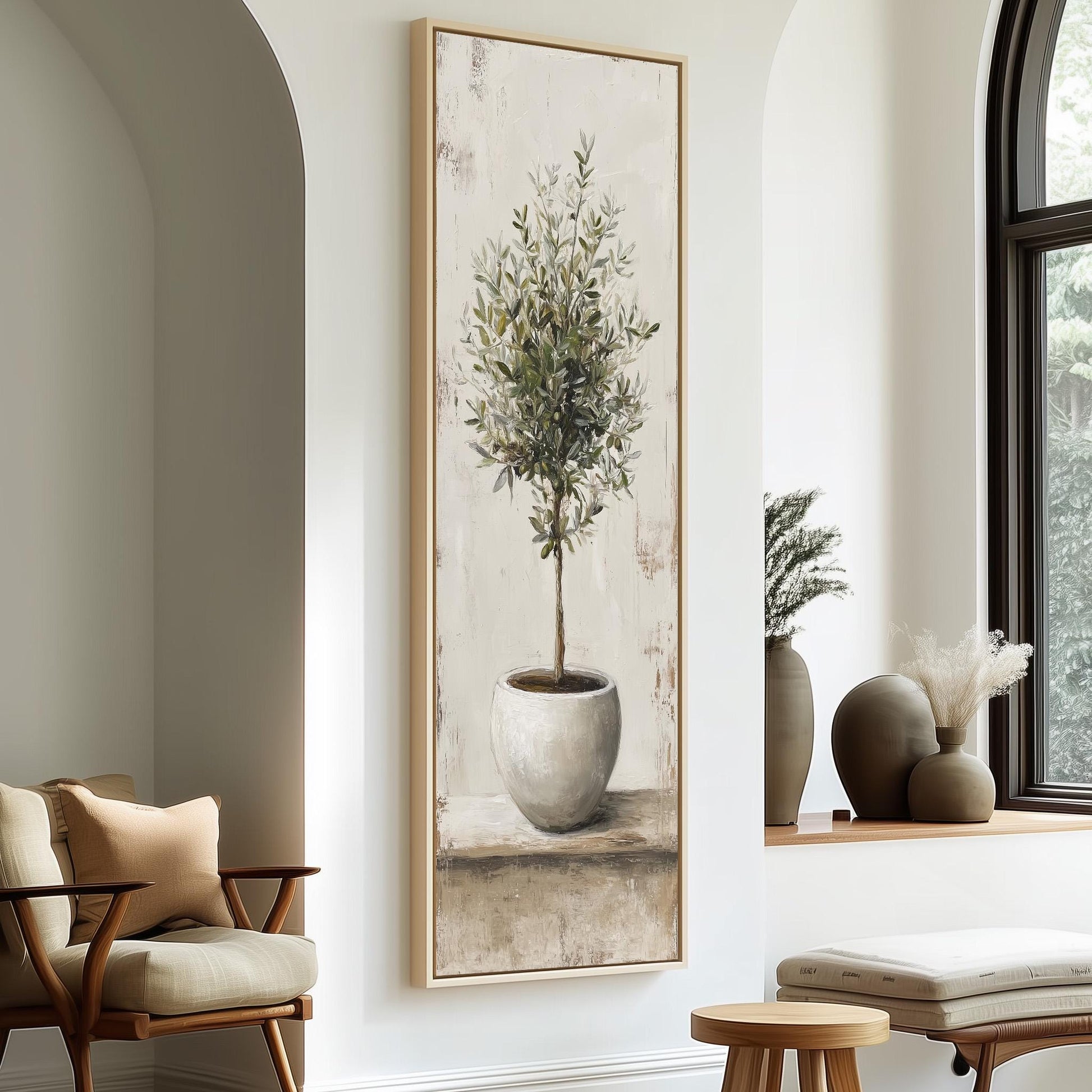 a large painting of a potted plant hanging on a wall, with a wooden chair and a small table in the foreground.