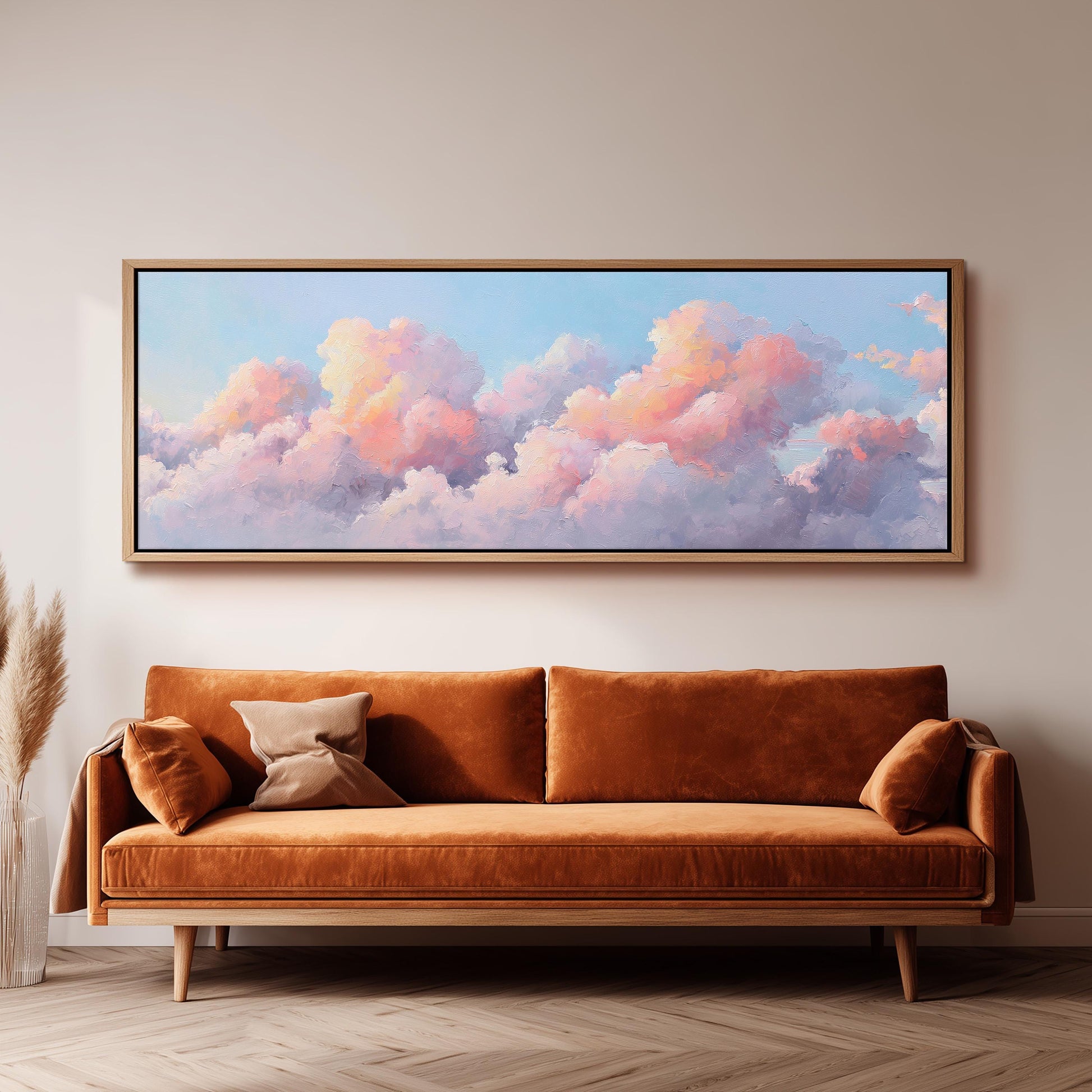 a large, framed painting of a cloudy sky hanging on a wall above a brown sofa.