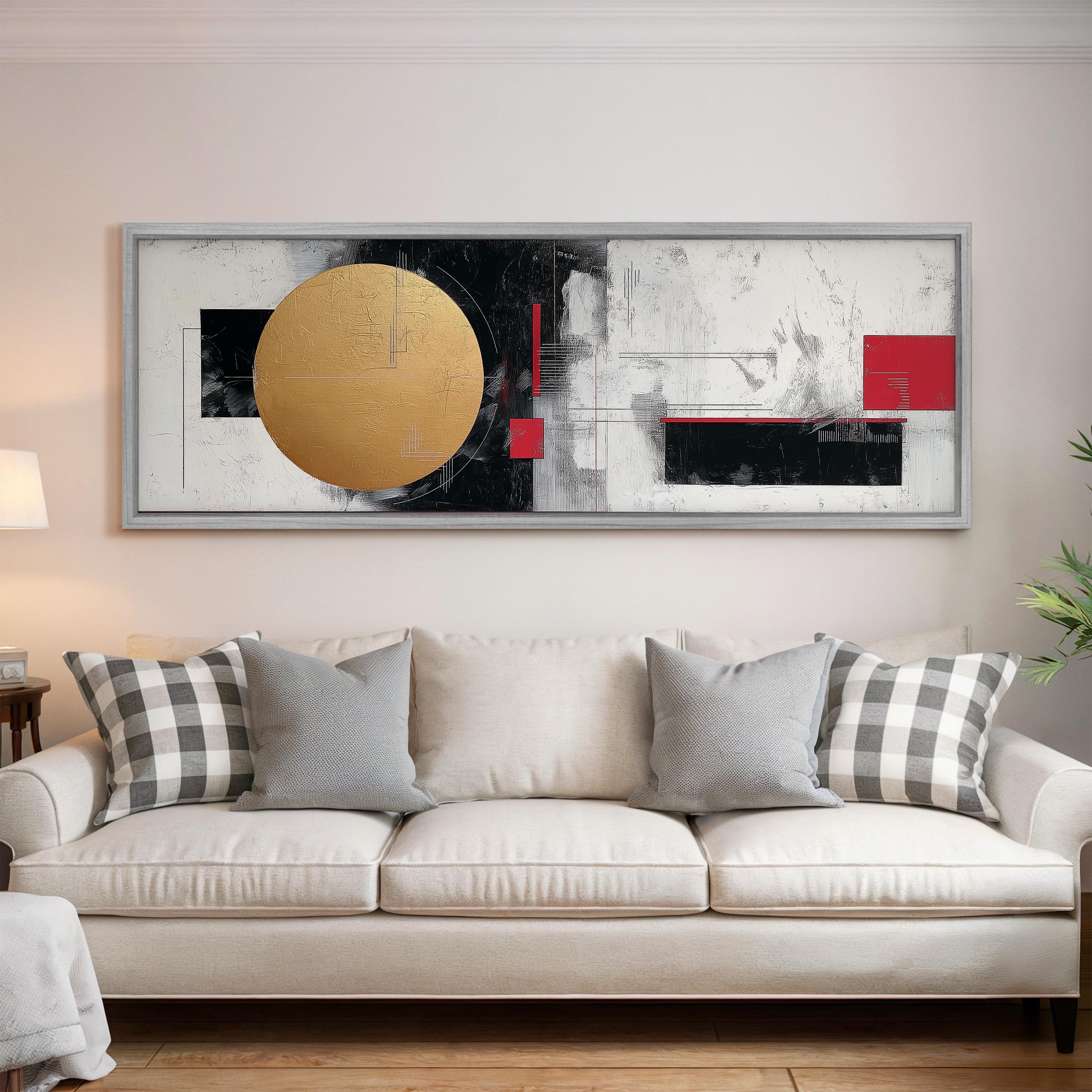 a large abstract painting hanging on a wall above a white couch with gray and black plaid throw pillows.