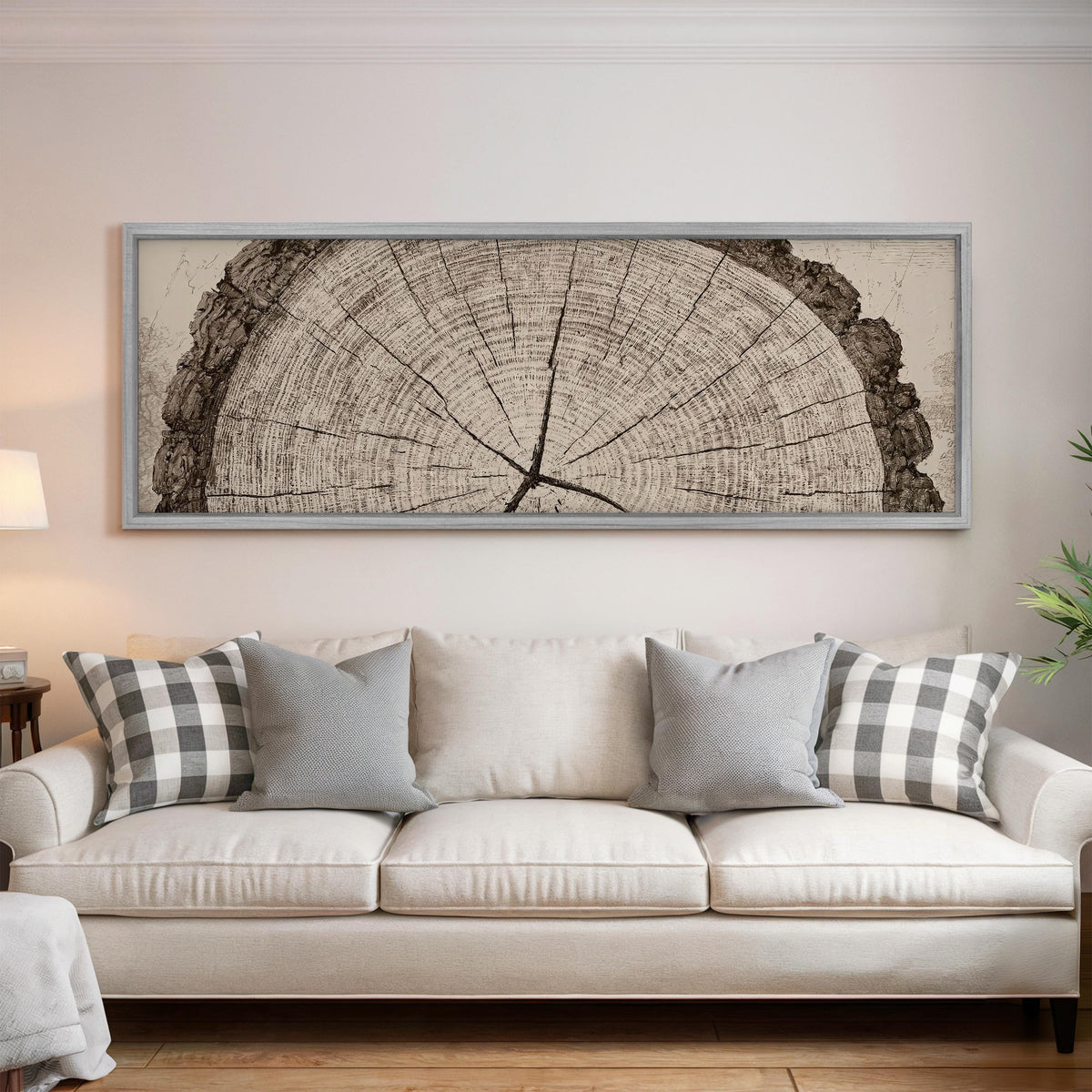 Sepia tree ring with radial cracks panoramic canvas print above a white sofa in a bright living room