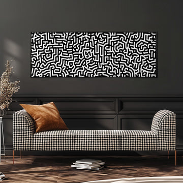 a modern living room with a black and white checkered sofa, a stack of books, and a large abstract painting on the wall.