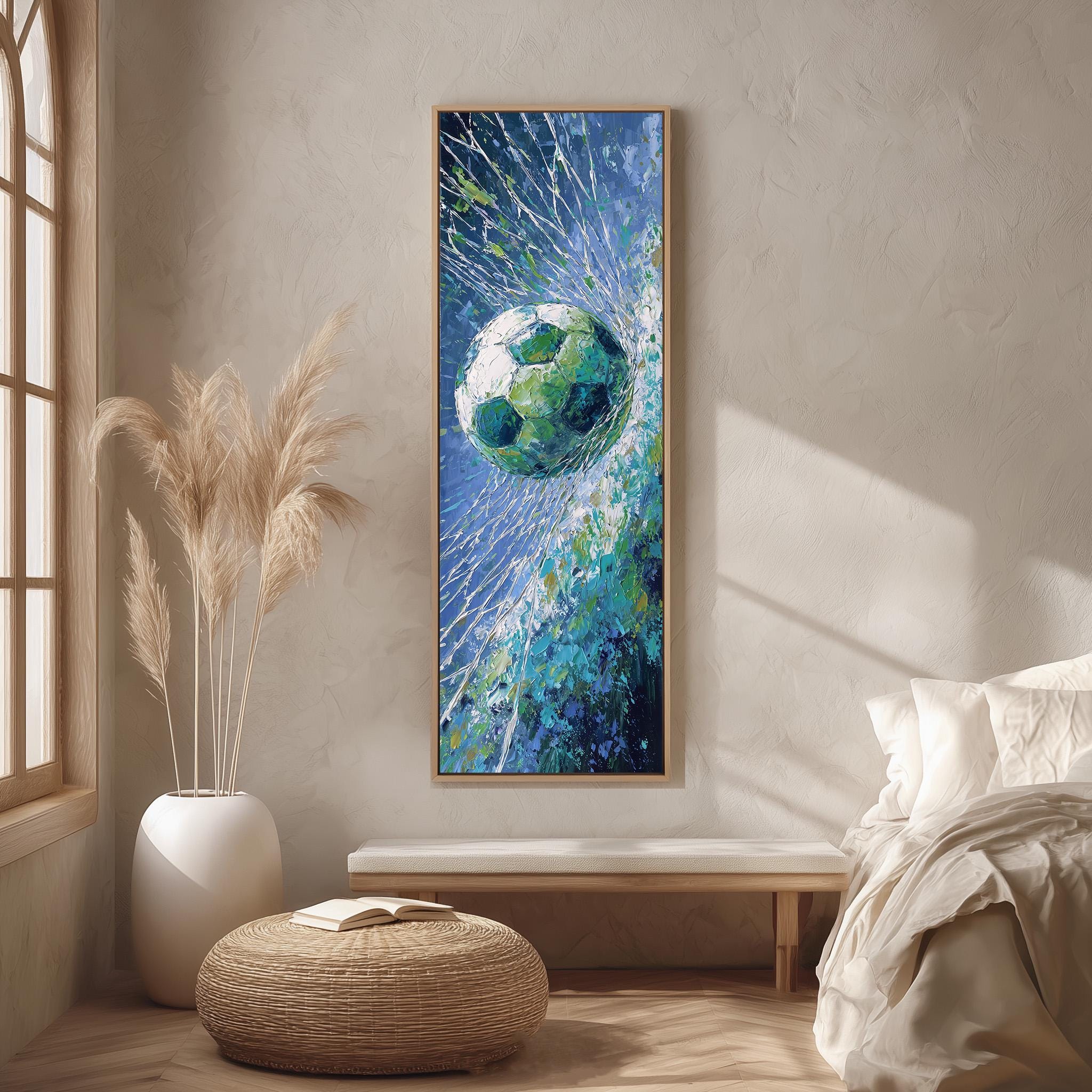 a large painting of a soccer ball suspended in mid-air, surrounded by a blue and green background, hanging on a wall in a room with a window and a white bench.