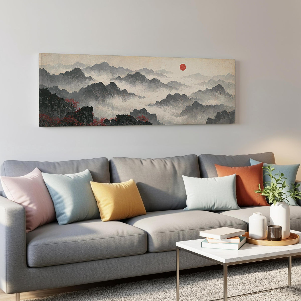 Misty ink mountains under a red sun panoramic canvas print above a grey sofa in a living room
