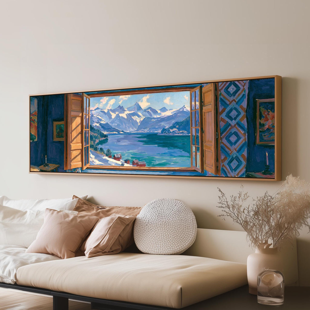 Snowy alpine lake seen through a window long horizontal canvas print above a sofa in a living room
