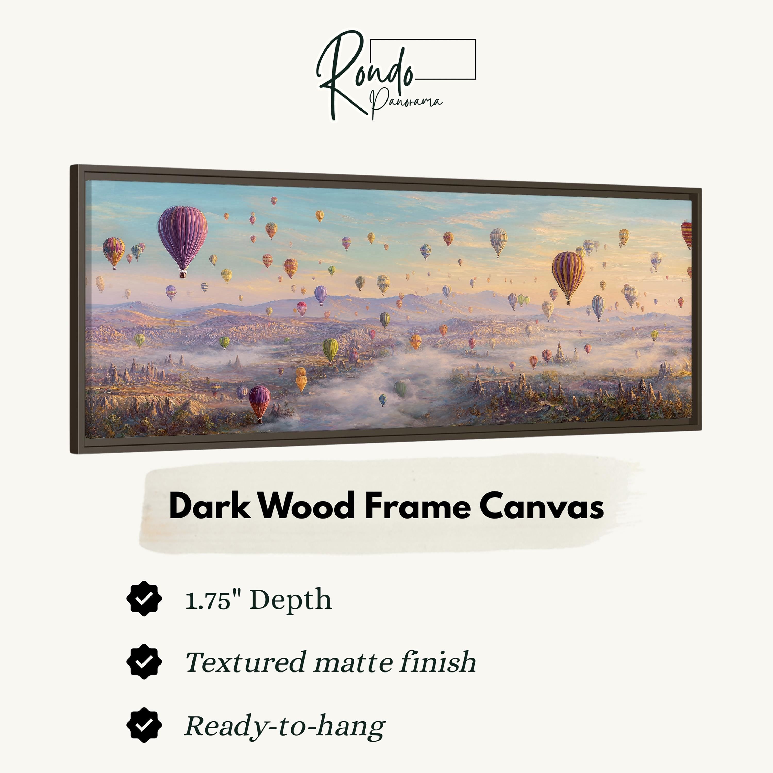 A framed painting depicting hot air balloons floating in the sky over a mountainous landscape.