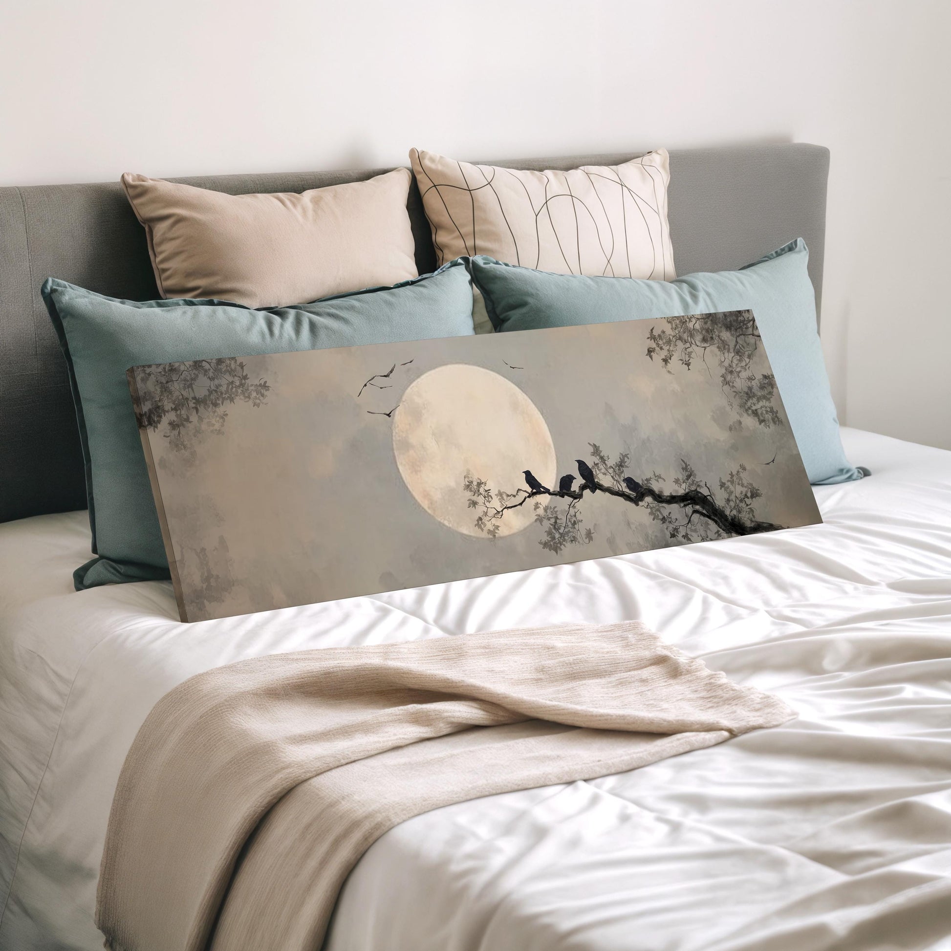 a bedroom with a bed and a large canvas print depicting a night scene with a full moon and silhouetted birds perched on a branch.
