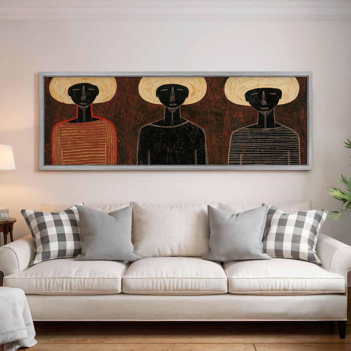 Three figures in striped shirts panoramic canvas print above a white sofa in a bright living room