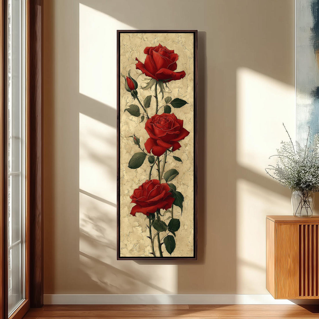 a large painting of three red roses hanging on a wall in a bedroom setting.