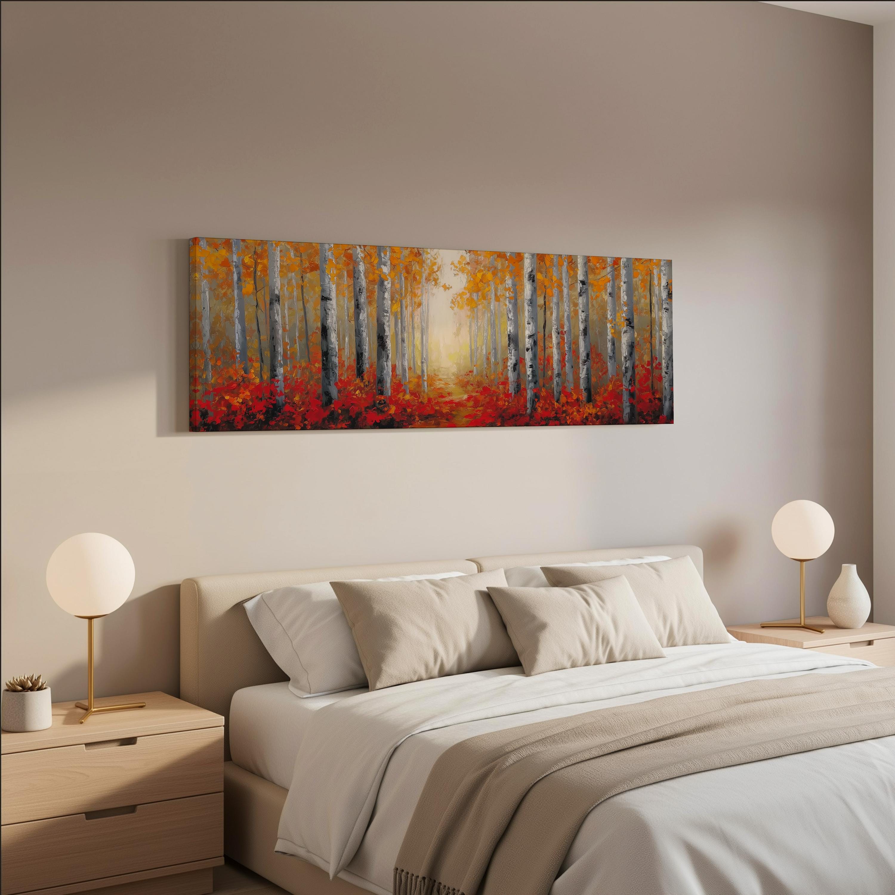 a serene bedroom scene with a large bed adorned with white linens and beige throw pillows. Above the bed, a large painting of a forest with tall trees and vibrant orange and red foliage hangs on the wall. Two white lamps flank the bed, providing a warm and inviting ambiance to the room.