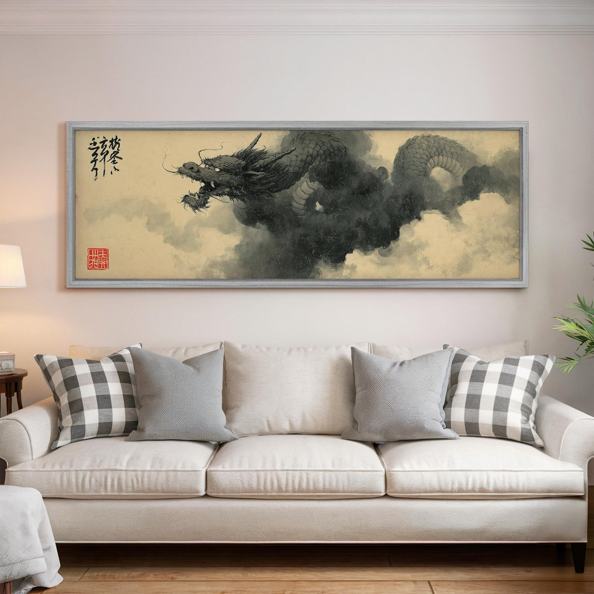 Ink dragon in the clouds panoramic canvas print above a white sofa in a bright living room