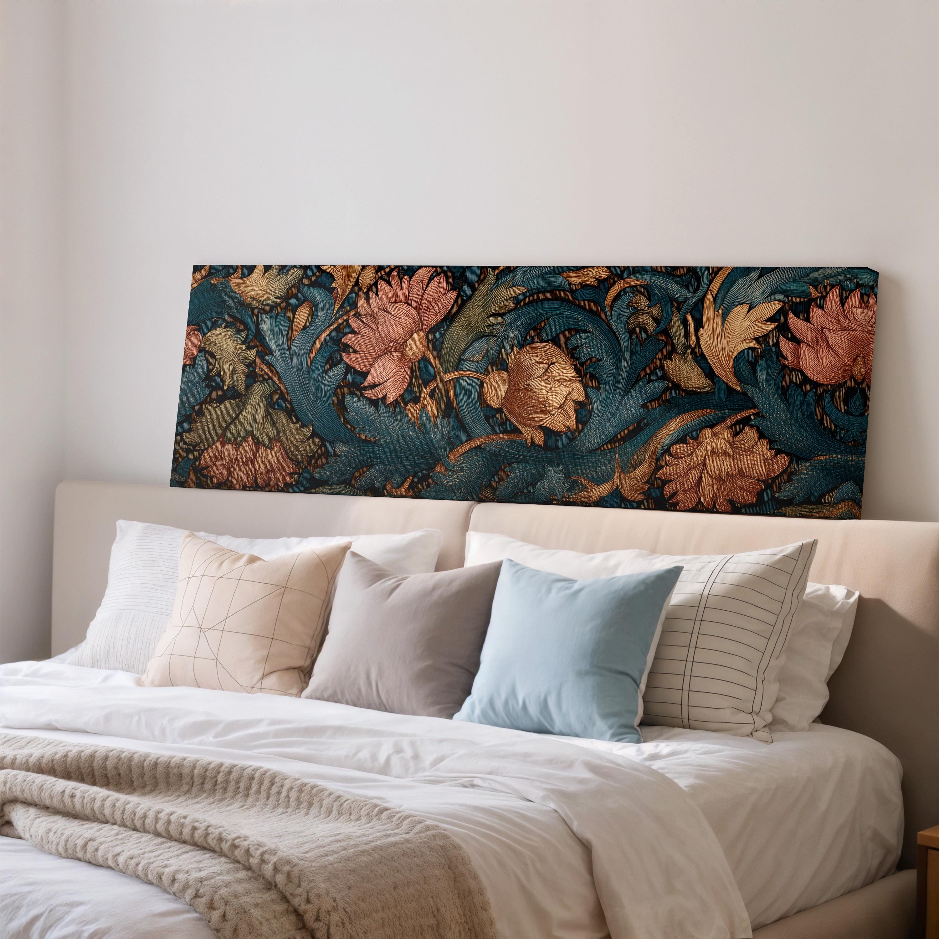 a large bed with a floral print headboard, adorned with a variety of pillows in different colors and patterns.
