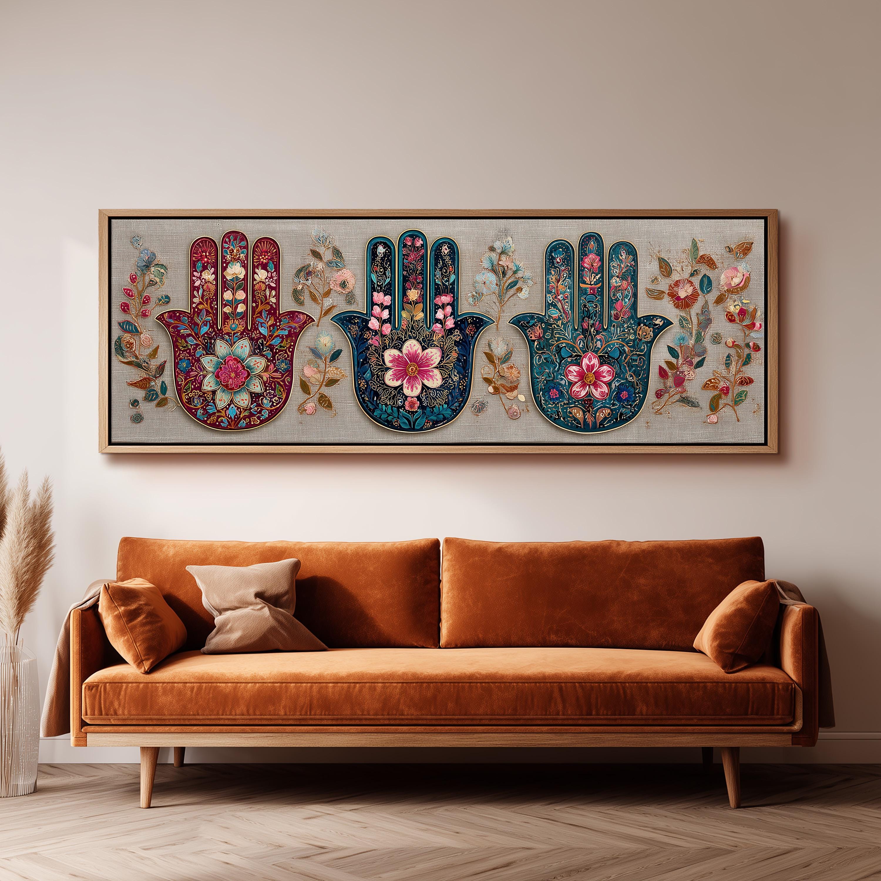 a large, ornate, and colorful painting of three stylized hands, each with a unique design and floral motif, hanging on a wall above a brown sofa.