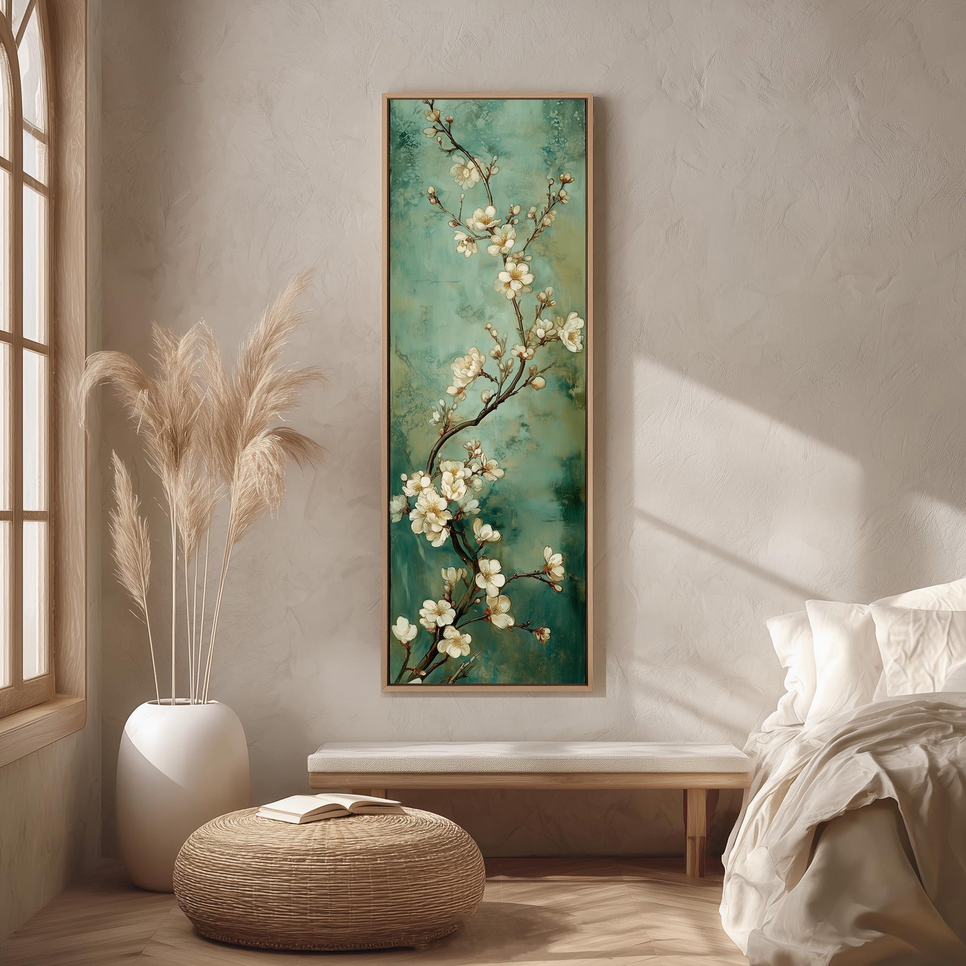 a serene and cozy bedroom scene, featuring a large painting of white flowers on a green background hanging on the wall, a white bed with a white pillow and blanket, a white wicker ottoman, and a large window with white curtains.