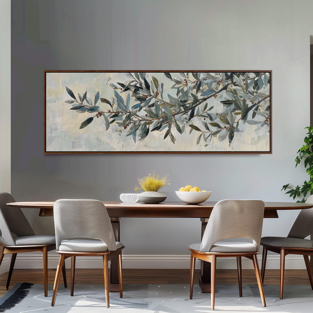 a dining room with a large painting of an olive tree hanging on the wall above a wooden dining table with four chairs. The table is set with a bowl of fruit and a vase of flowers, creating a cozy and inviting atmosphere.