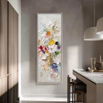 a large, colorful painting hanging on a wall in a modern kitchen.