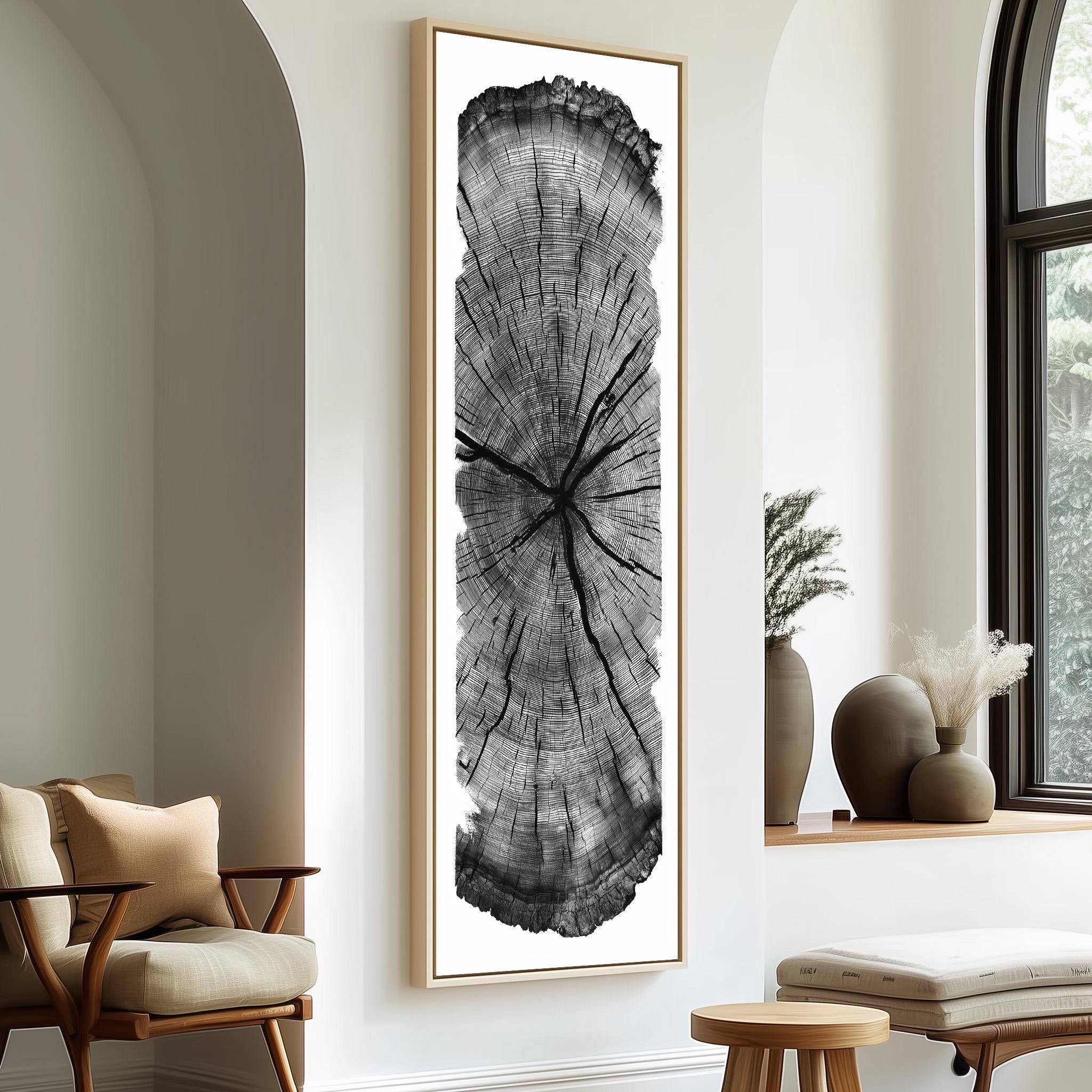 a large, black and white tree trunk with a cross-like pattern, mounted on a wall in a minimalist living room setting.