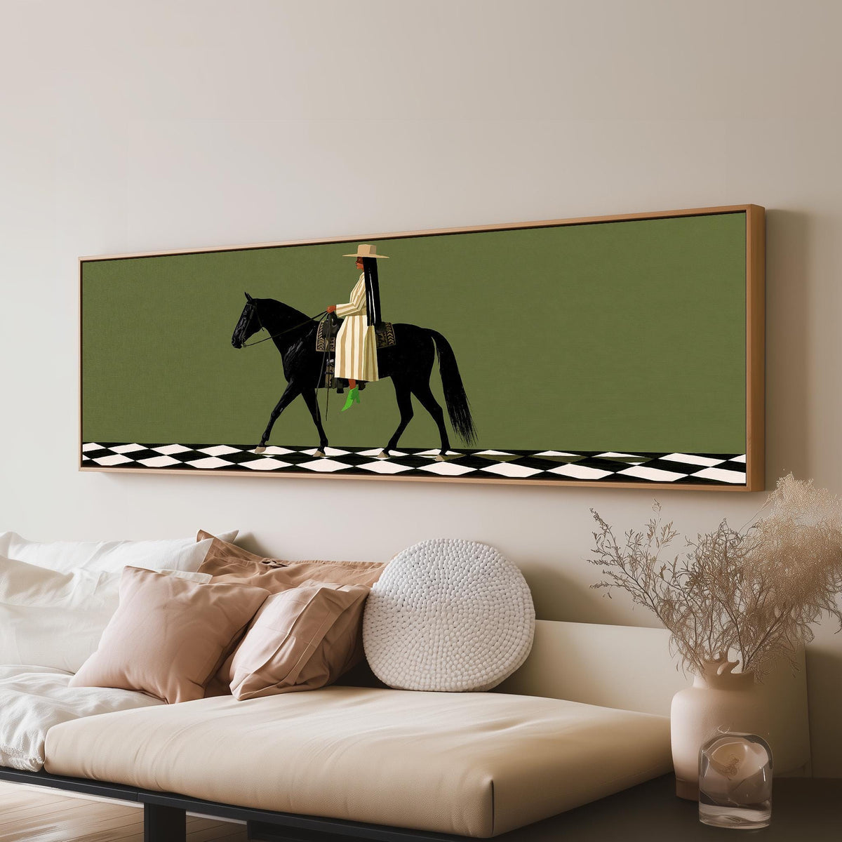 Woman riding a black horse on a checkerboard long horizontal canvas print above a sofa in a living room