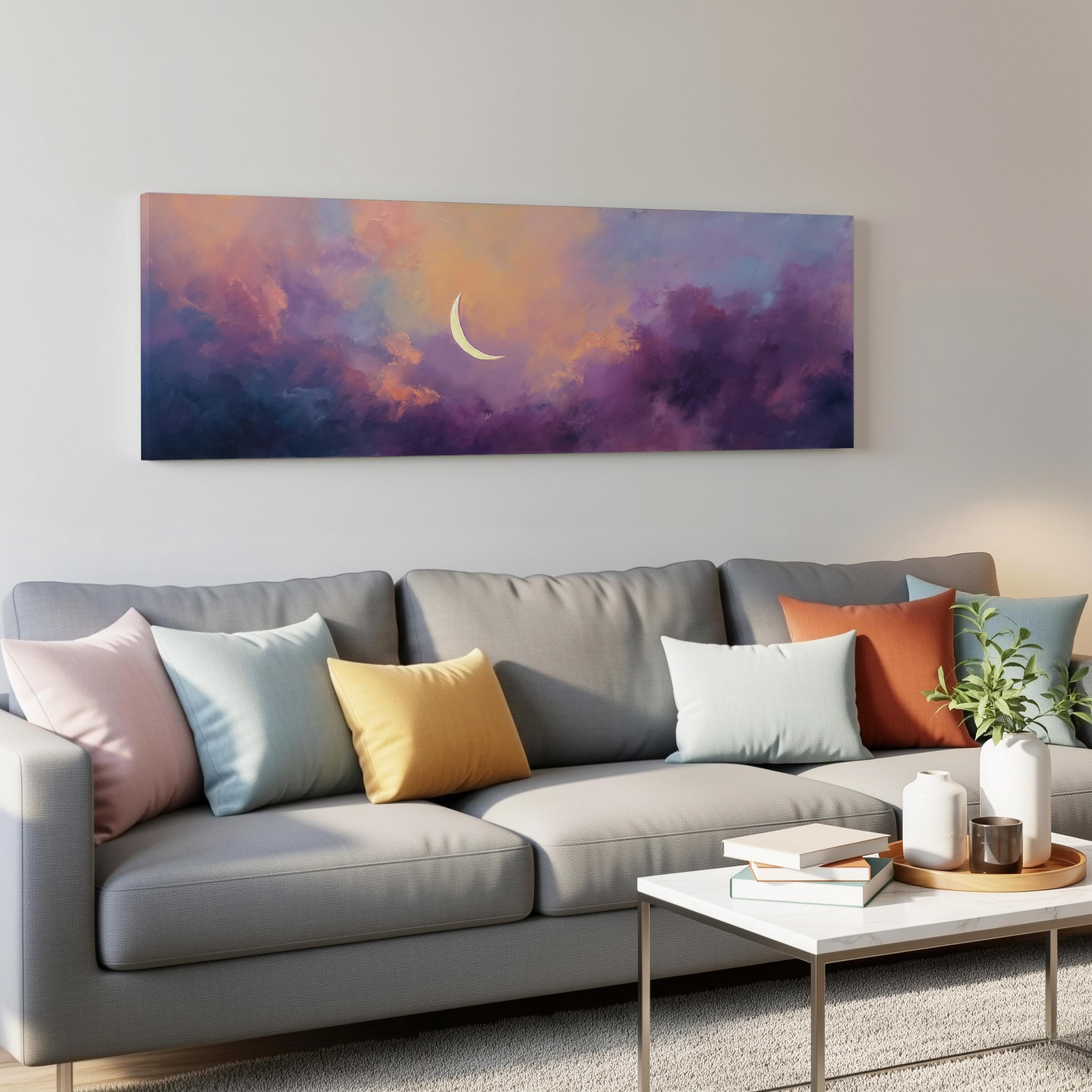 a gray couch with colorful throw pillows, a coffee table, and a painting of a crescent moon on the wall above it.