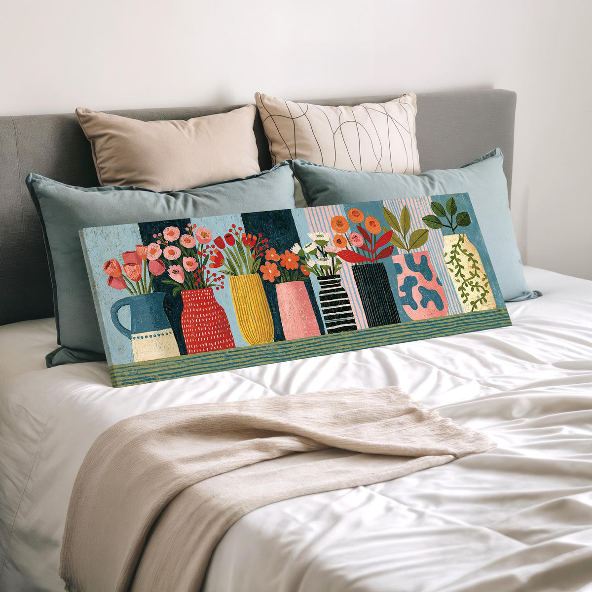 Row of folk art flower vases wide panoramic canvas print laid on a bed to show its size