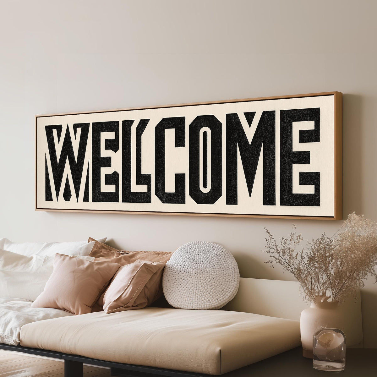 Bold welcome block letters panoramic canvas print above a sofa in a living room