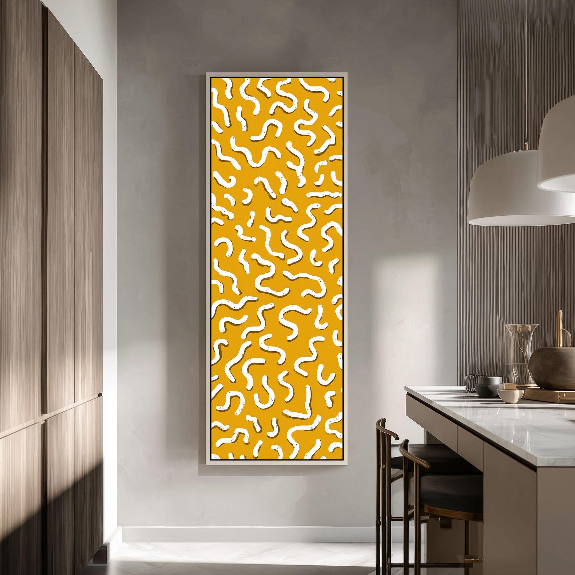 a modern kitchen with a large, abstract yellow and white patterned wall hanging as the focal point. The kitchen has a clean, minimalist design with white cabinets and a white countertop.
